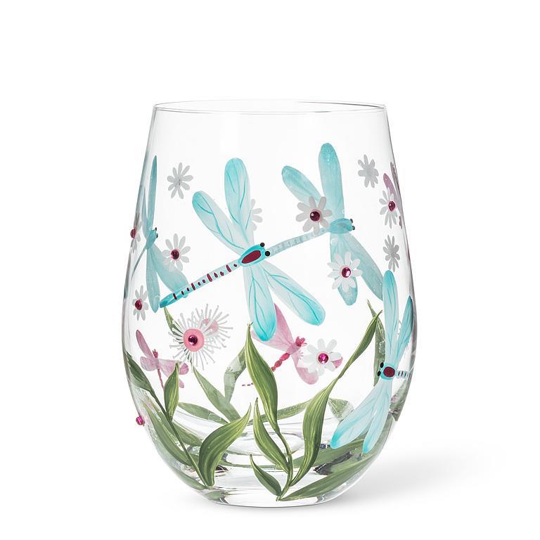 Verre à vin sans pied transparent orné d'illustrations peintes de libellules bleu turquoise et roses, de longues feuilles vertes et de fleurs délicates à cœur brillant.