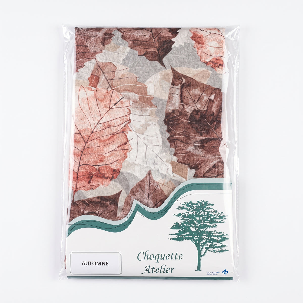 Nappe d'automne pliée sous emballage plastique, marque Choquette Atelier, modèle Automne avec de grandes feuilles dans les tons marron, terracotta et beige.